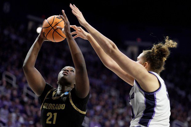 Colorado center Aaronette Vonleh (21) shoots under pressure from Kansas State center Ayoka Lee during the second half of a second-round college basketball game in the women's NCAA Tournament in Manhattan, Kan., Sunday, March 24, 2024, in Manhattan, Kan. Colorado won 63-50. (AP Photo/Charlie Riedel)