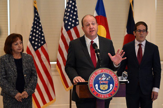 Colorado Gov. Jared Polis, with Lt. Gov. Dianne Primavera, left, and Mark Ferrandino, executive director of the Colorado Department of Revenue, right, speaks during a press conference at the Carriage House at the Governor's Residence at Boettcher Mansion on Nov. 1, 2023 in Denver. The governor released his budget proposal today on the required deadline.  It's basically his desired budget that gets forwarded to the legislature, which then crafts that budget between January and May. The Governor highlighted his priorities and special projects. (Photo by Helen H. Richardson/The Denver Post)