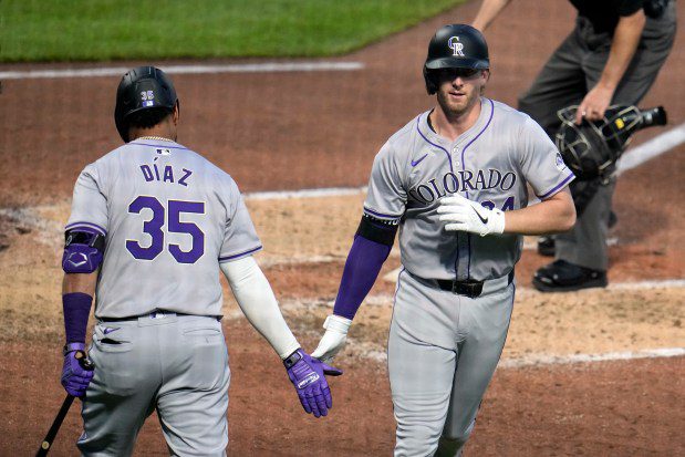 Colorado Rockies' Ryan McMahon, right, is greeted by Elias Díaz as he heads to the dugout after hitting a solo home run off Pittsburgh Pirates starting pitcher Martín Pérez during the sixth inning of a baseball game in Pittsburgh, Friday, May 3, 2024. (AP Photo/Gene J. Puskar)